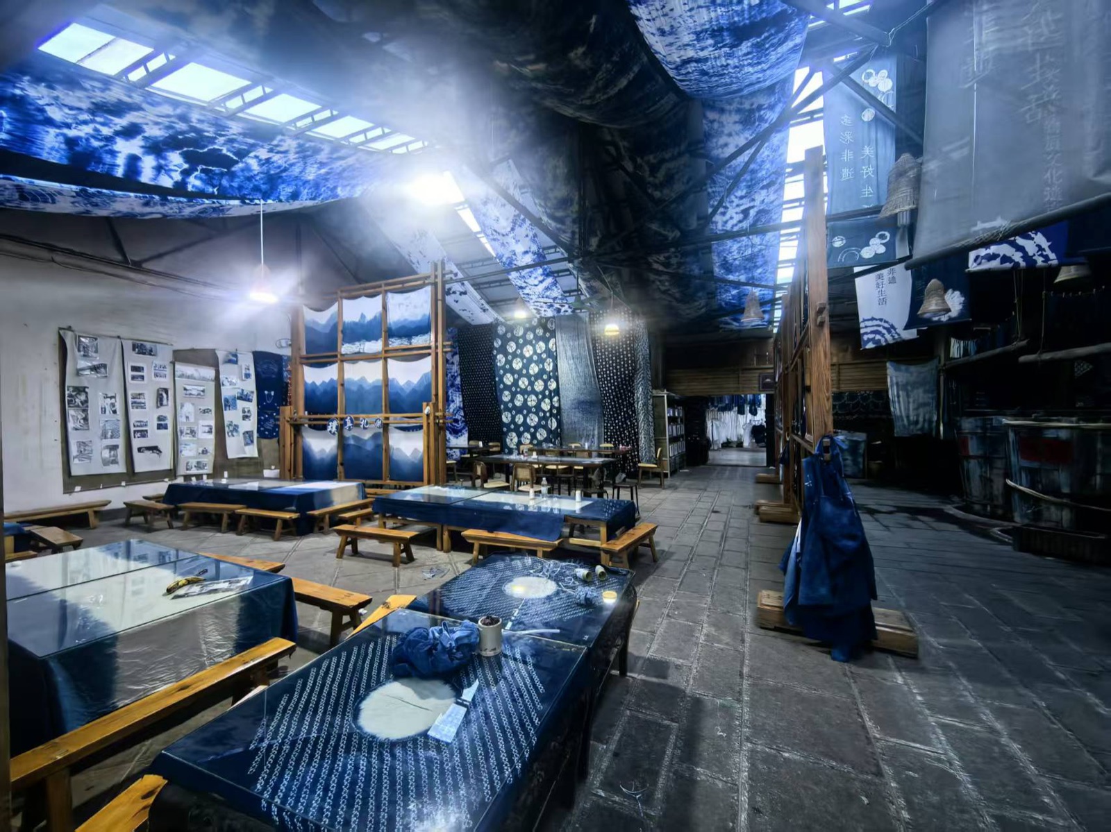 Indigo-dyed cloth hanging in a Bai tie-dye workshop in Zhoucheng, Dali