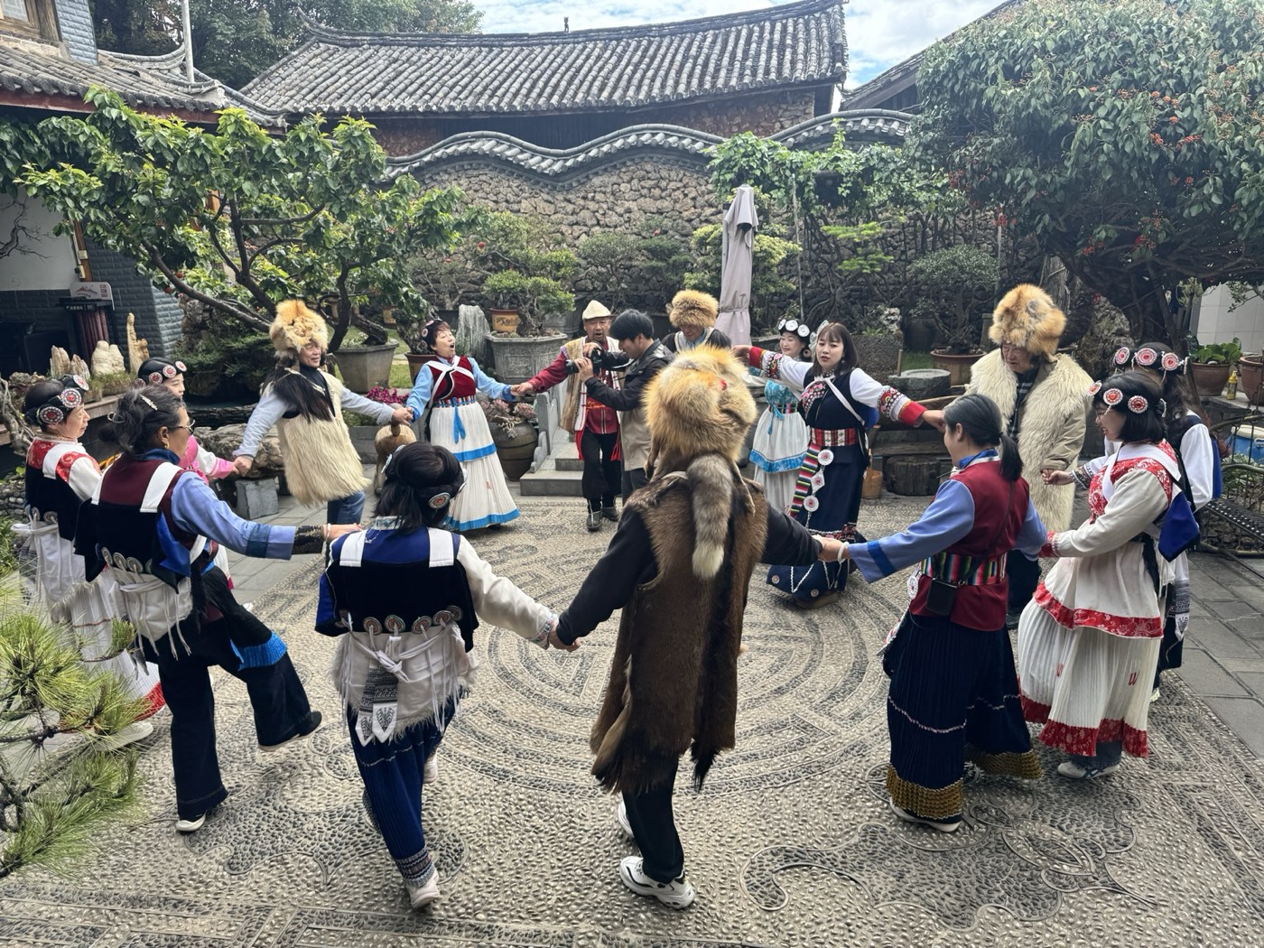 Naxi group circle dance in a stone-paved Lijiang courtyard